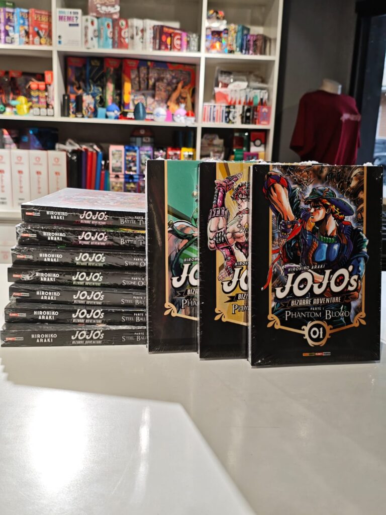 Primeiros volumes de JoJo's Bizarre Adventure Parte 7: Steel Ball Run enfileirados, mostrando as capas com os personagens Johnny Joestar e Gyro Zeppeli em ilustrações dinâmicas de Hirohiko Araki, com fundos em tons terrosos e elementos de faroeste.
